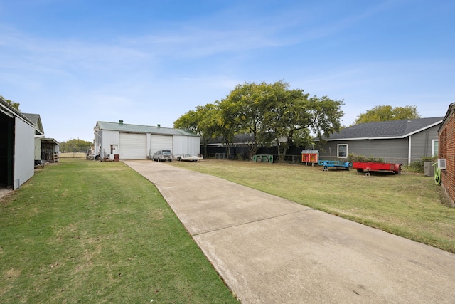 view of yard featuring a garage and an outbuilding