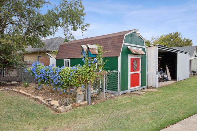 view of outbuilding featuring a lawn