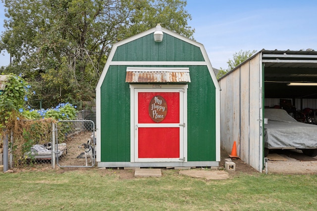 view of outbuilding featuring a yard