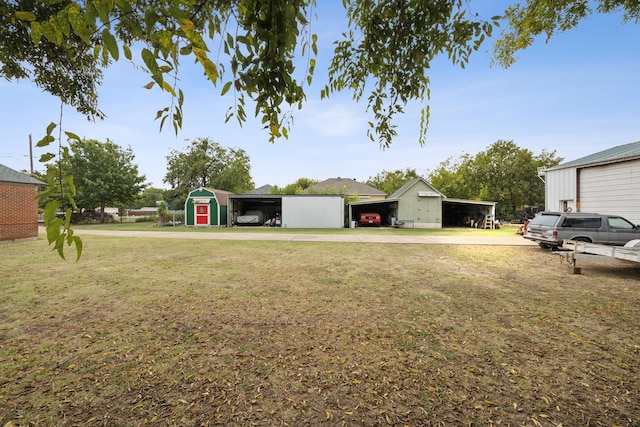 view of yard with an outdoor structure and a carport