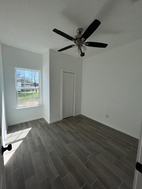 spare room with dark hardwood / wood-style flooring, a textured ceiling, and ceiling fan