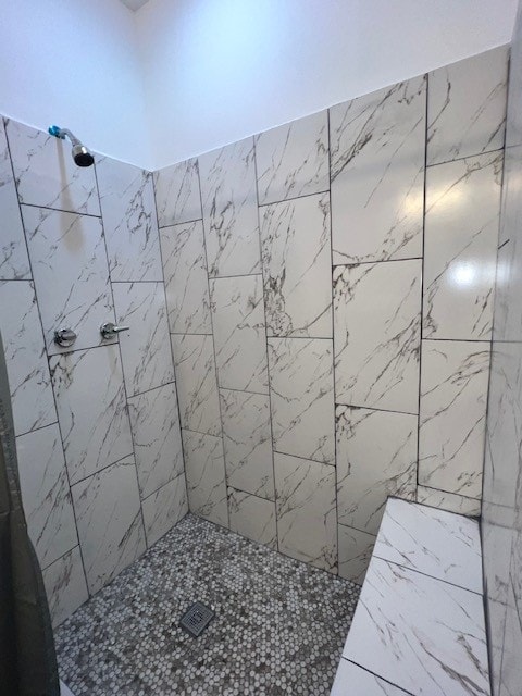 bathroom with tiled shower