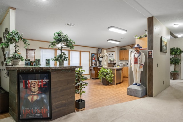 interior space featuring crown molding and light hardwood / wood-style flooring