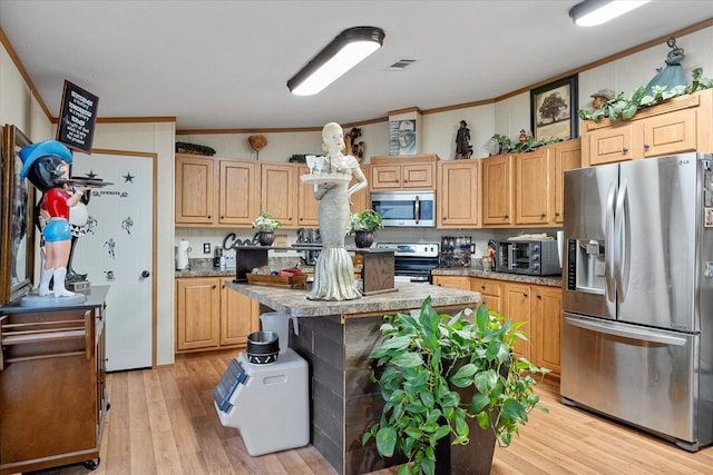 kitchen featuring crown molding, stainless steel appliances, a center island, light hardwood / wood-style floors, and light brown cabinets