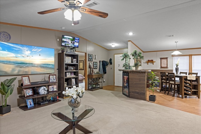 interior space with lofted ceiling, crown molding, and ceiling fan