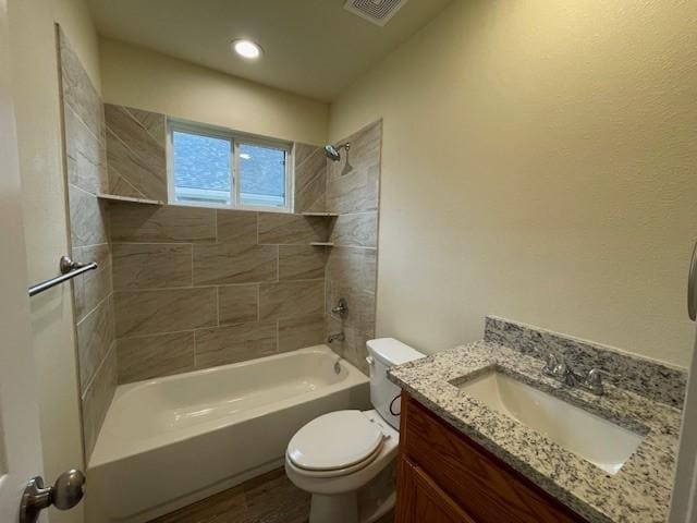 full bathroom with toilet, vanity, hardwood / wood-style floors, and tiled shower / bath