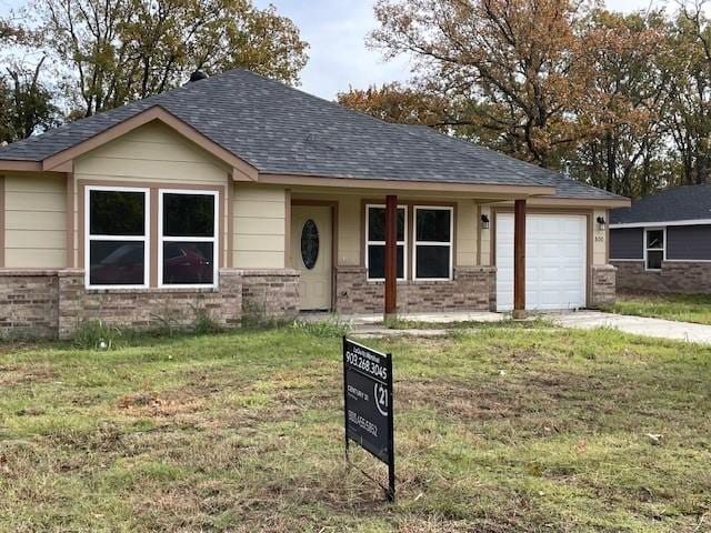 view of front of property with a garage and a front lawn