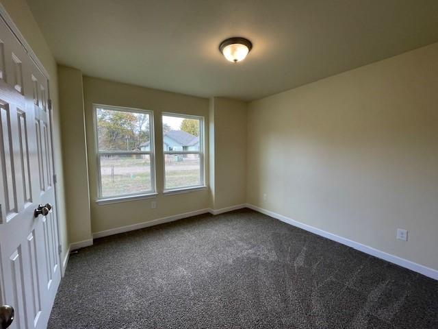 empty room with dark carpet