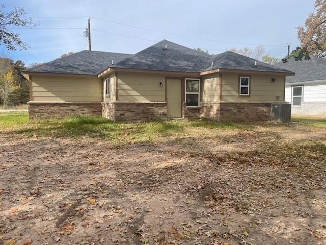 rear view of house featuring central AC unit