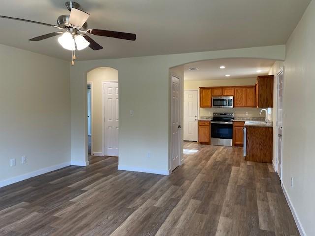 kitchen featuring ceiling fan, dark hardwood / wood-style flooring, sink, and appliances with stainless steel finishes