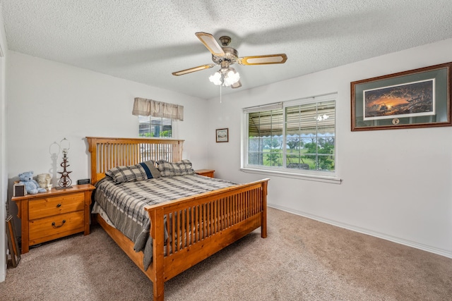 bedroom with carpet flooring, a textured ceiling, and ceiling fan