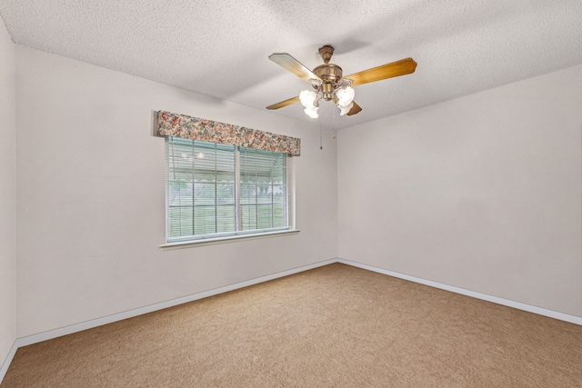 empty room with ceiling fan, a textured ceiling, and carpet floors