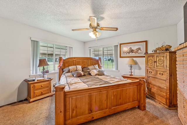 carpeted bedroom featuring a textured ceiling and ceiling fan