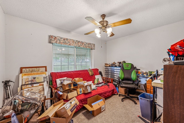 carpeted office space featuring ceiling fan and a textured ceiling