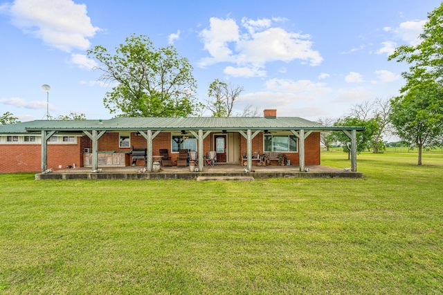 back of property featuring a lawn and a patio