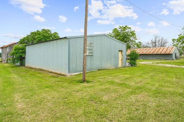 view of outbuilding with a yard