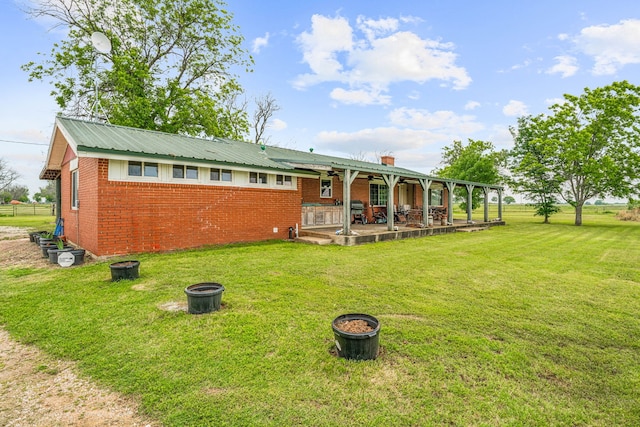 back of house featuring a patio area and a yard