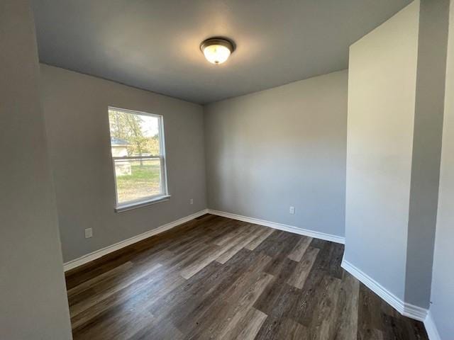 empty room with dark hardwood / wood-style floors