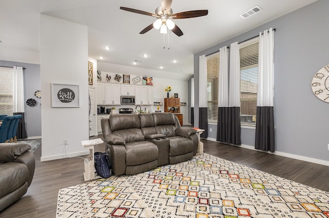 living room with ceiling fan and hardwood / wood-style floors