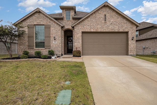 view of front of property with a garage and a front lawn