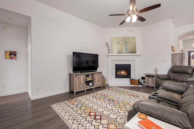 living room featuring dark hardwood / wood-style flooring and ceiling fan