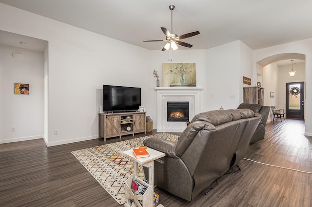 living room featuring dark hardwood / wood-style floors and ceiling fan