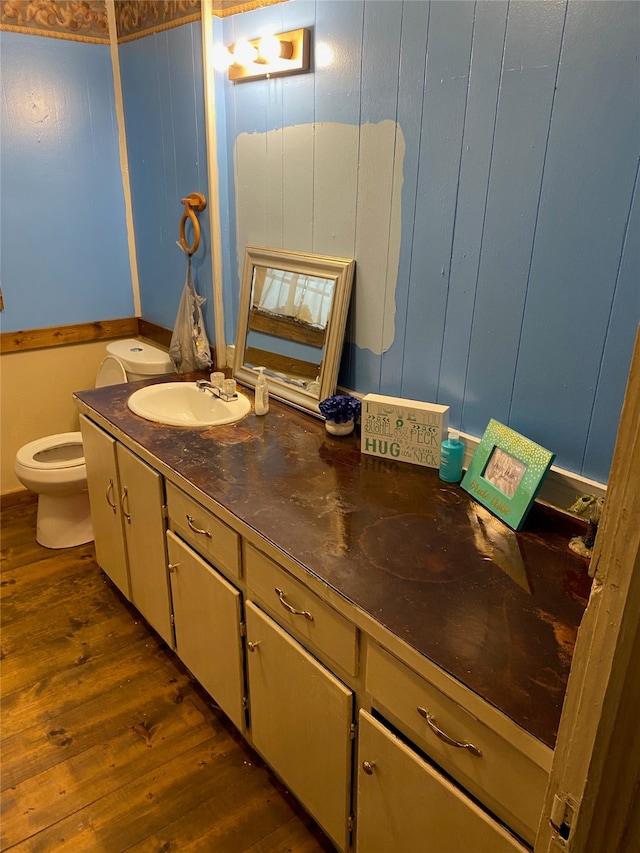 bathroom featuring hardwood / wood-style floors, vanity, and toilet