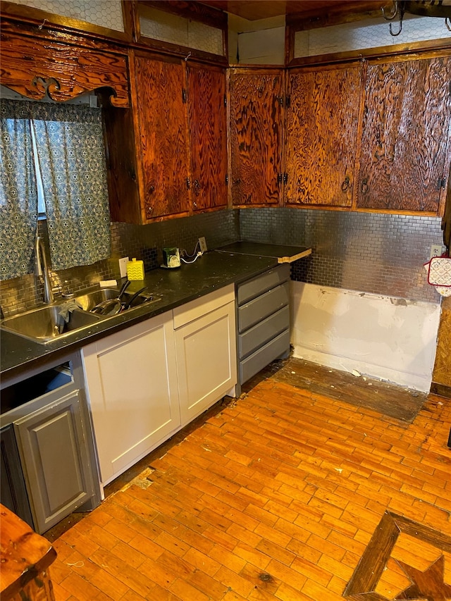 kitchen featuring tasteful backsplash, white cabinetry, and light hardwood / wood-style floors