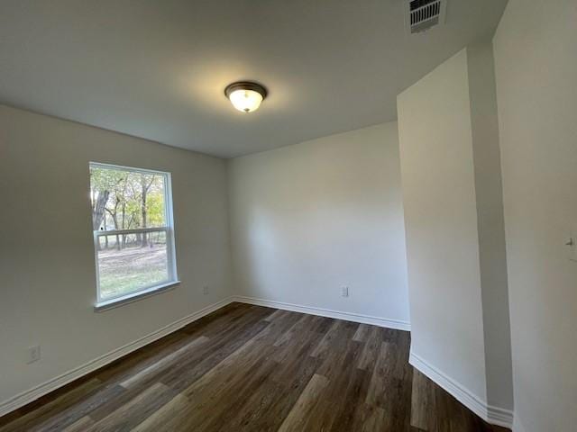 spare room with dark hardwood / wood-style floors