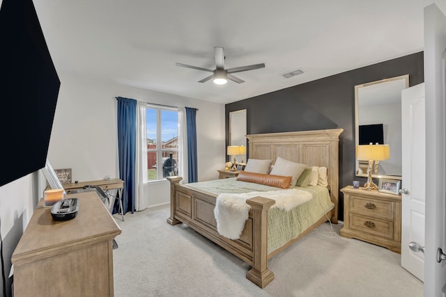 bedroom with ceiling fan and light colored carpet