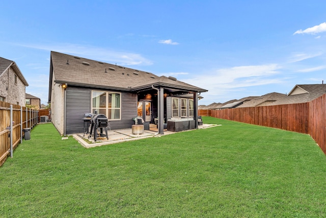 back of property with a yard and a patio area