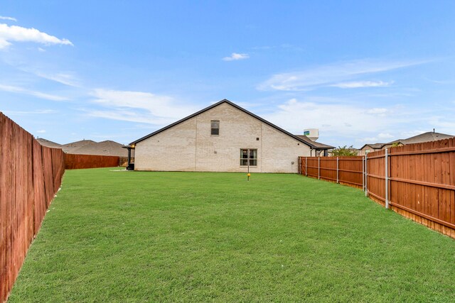 back of house with a lawn