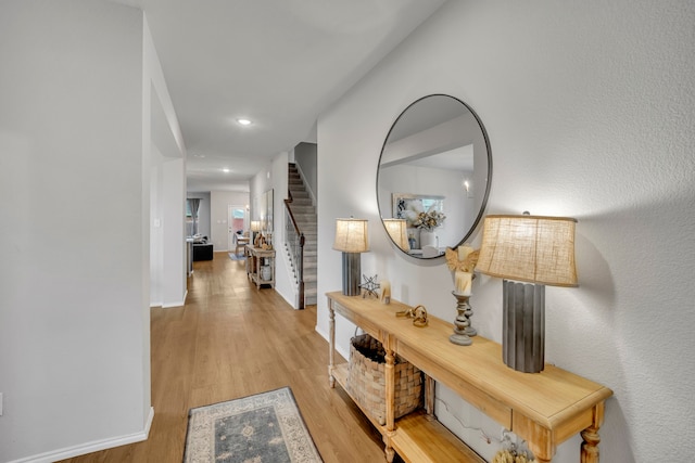 corridor with light hardwood / wood-style floors