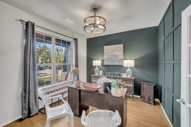 office area featuring an inviting chandelier and light wood-type flooring