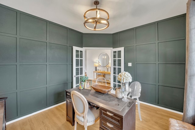 home office with light hardwood / wood-style floors