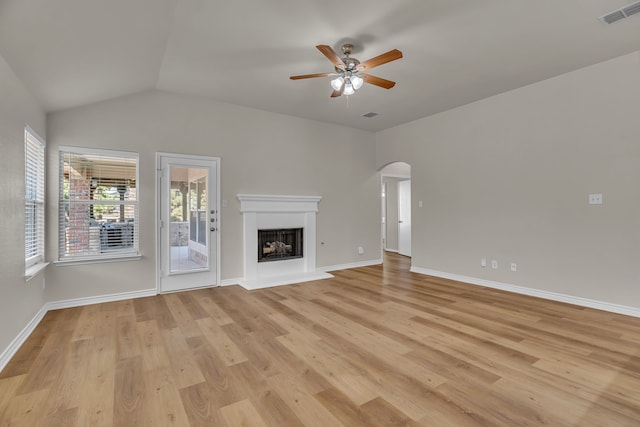 unfurnished living room with light hardwood / wood-style floors, ceiling fan, and vaulted ceiling