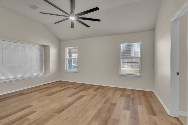 spare room with light wood-type flooring, lofted ceiling, and ceiling fan