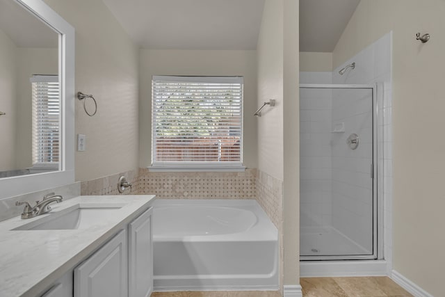 bathroom featuring vanity, plus walk in shower, and lofted ceiling