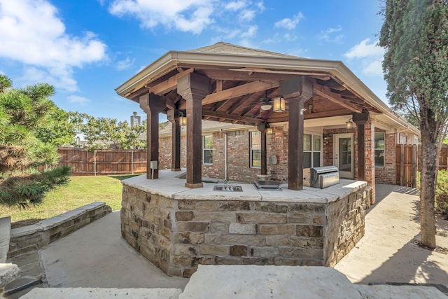 view of patio / terrace featuring ceiling fan, a gazebo, and grilling area