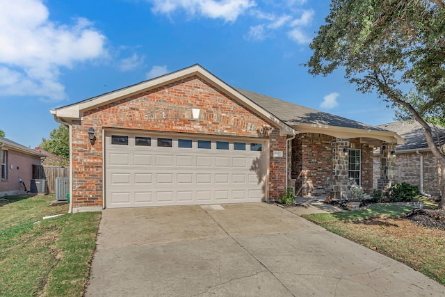 ranch-style home featuring a garage, central AC, and a front yard