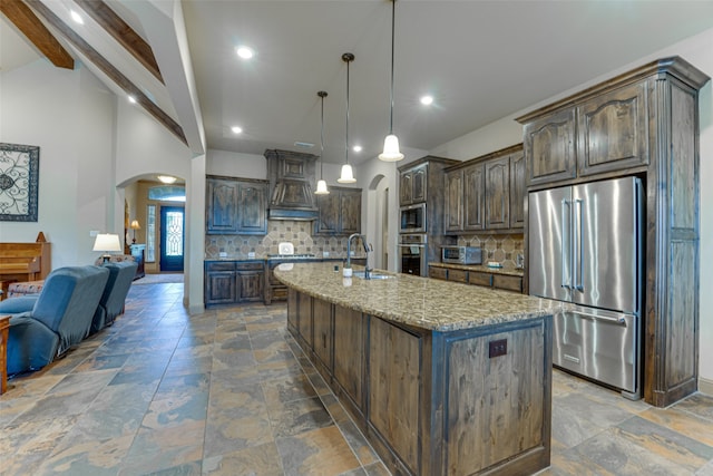 kitchen featuring custom exhaust hood, sink, dark brown cabinetry, and stainless steel appliances