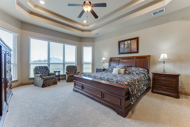 carpeted bedroom featuring ornamental molding, multiple windows, and ceiling fan