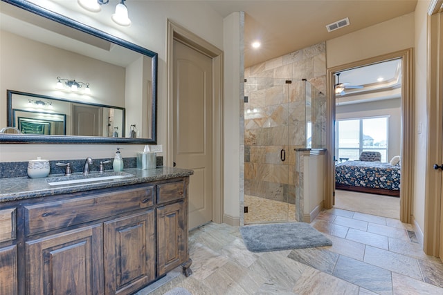 bathroom with walk in shower, vanity, and ceiling fan