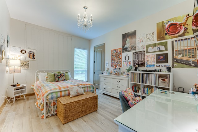 bedroom with wood walls, a chandelier, and light hardwood / wood-style flooring