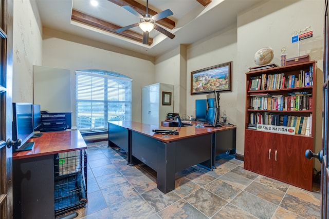 office with ceiling fan and a raised ceiling