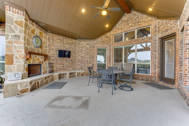 view of patio featuring ceiling fan and an outdoor stone fireplace