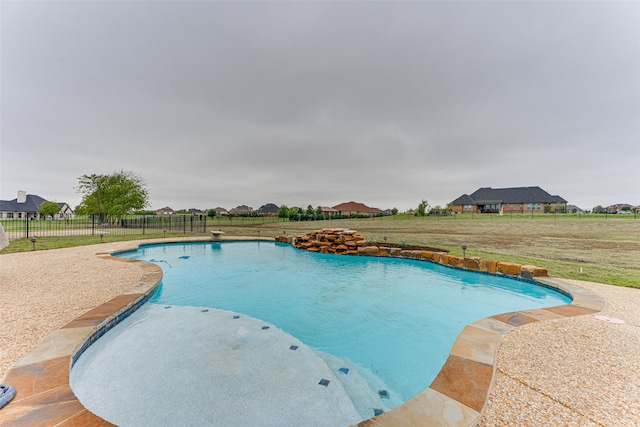 view of pool with a patio and a yard