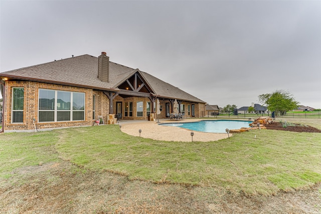 view of pool featuring a lawn and a patio