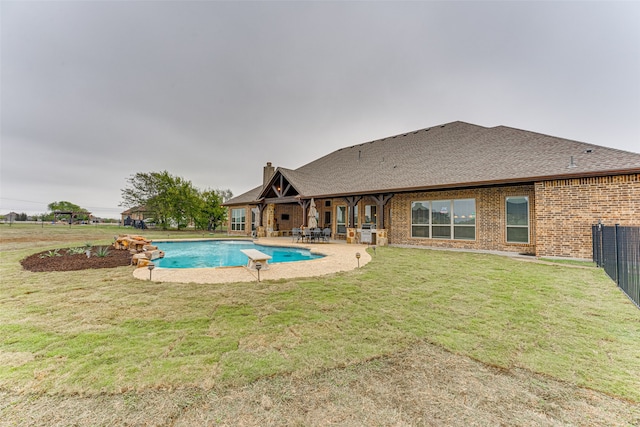 view of pool with a patio and a yard