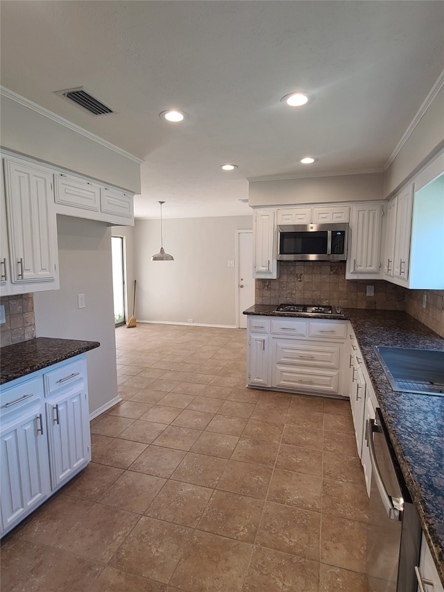 kitchen with appliances with stainless steel finishes and white cabinets